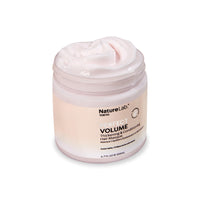 Perfect Volume Thickening & Conditioning Hair Masque. The jar is angled facing the right about 45 degrees, and the lid is open to show the whipped, creamy texture of the masque and its pale pink color.