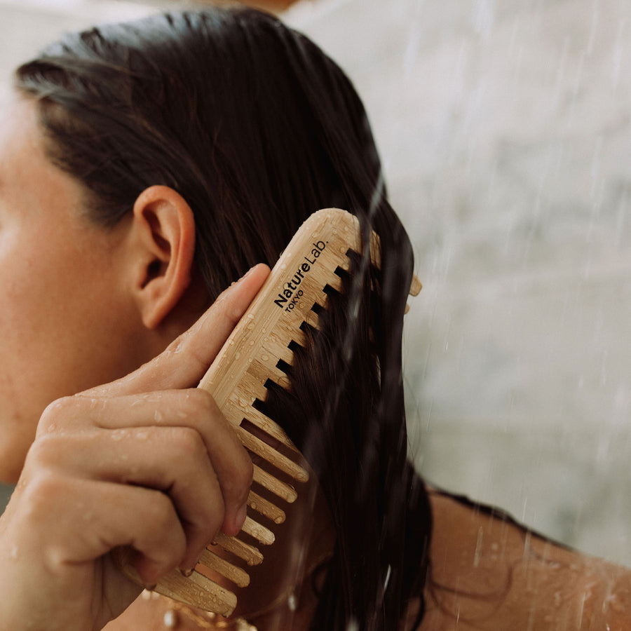 bamboo comb on model in shower