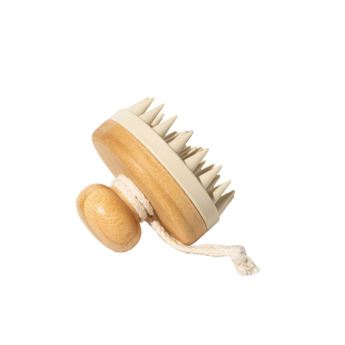 Wooden scalp massage tool with soft silicon spikes on a white background