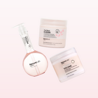Perfect Volume Shampoo, Perfect Clean 2-in-1 Scalp Scrub & Clarifying Shampoo: Sakura, and Perfect Volume Thickening & Conditioning Hair Masque arranged in a triangular formation at different angles, as if floating. The background is a very pale pink gradient.