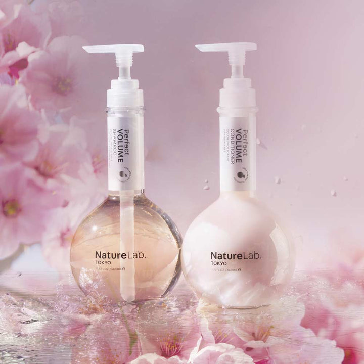 Volume Shampoo & Conditioner Duo on cherry blossom background.