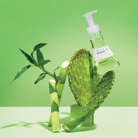 Repair Leave In Treatment on green background with bamboo and prickly pear.