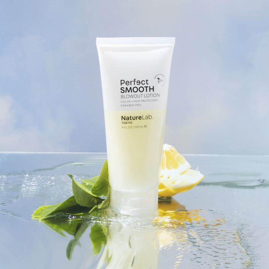 Smooth Blowout Lotion on sky background with fruit.
