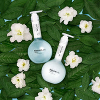 Texture Shampoo & Conditioner Duo on alpine rose flower background.